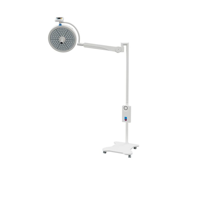 A mobile Komax LED surgical light head mounted on a sturdy, four-caster floor stand with a balanced spring arm for flexible positioning, featuring a white heat-efficient aluminum body and central sterilizable handle.
