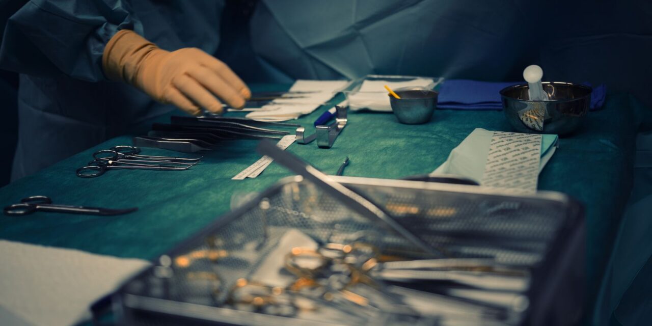 Sterile surgical instruments arranged on theatre tables