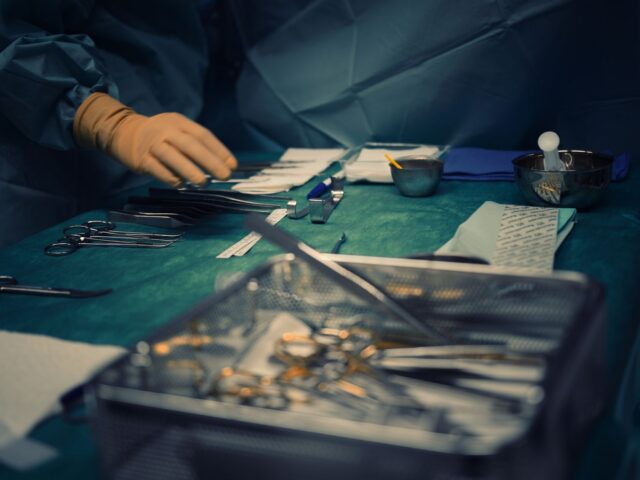 Sterile surgical instruments arranged on theatre tables