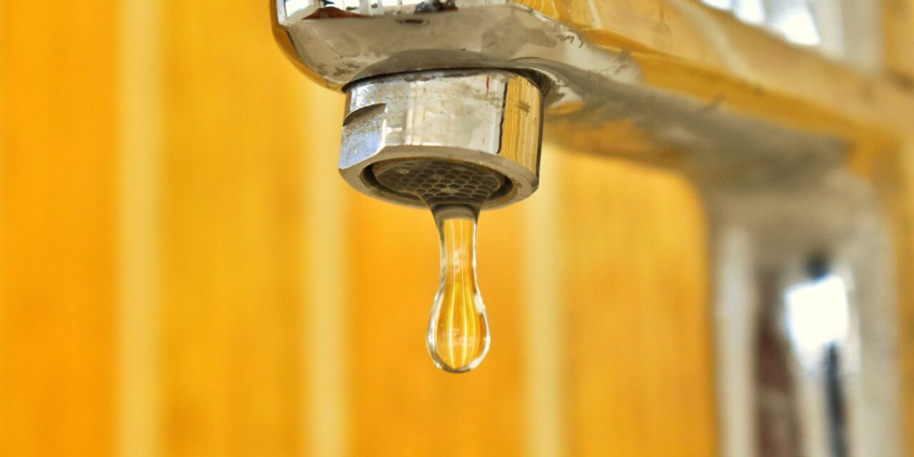 Water droplet on a stainless steel faucet