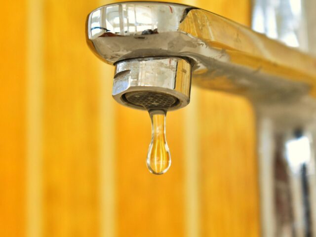 Water droplet on a stainless steel faucet